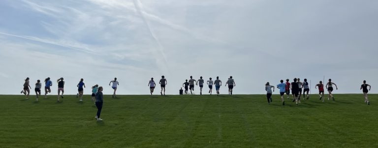 High school athletes running up a hill